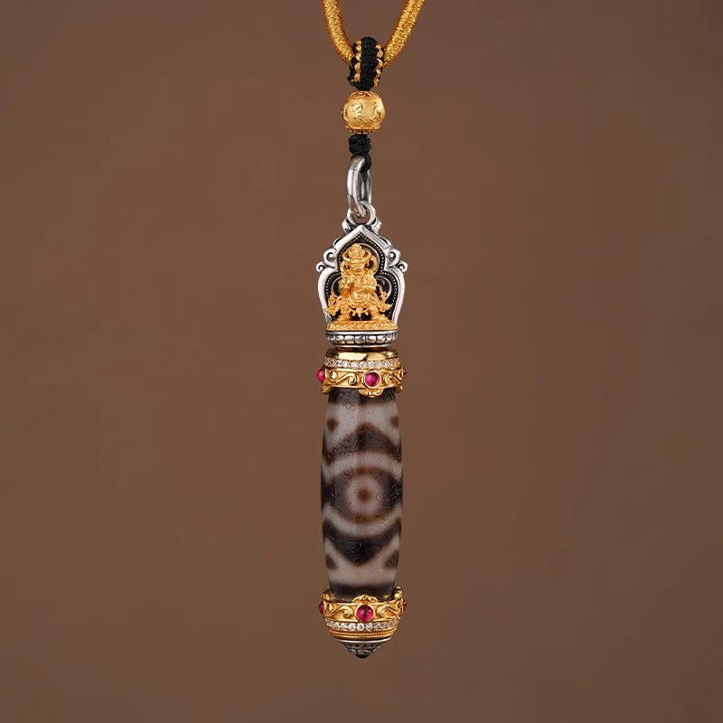 Back view of dzi pendant with golden deity sculpture and gemstone setting
