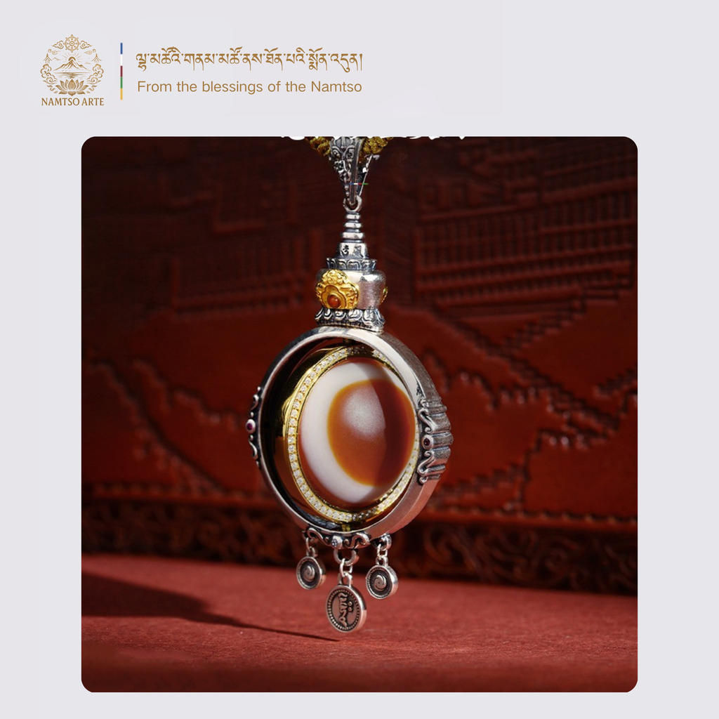 Side view of Tibetan dzi eye pendant with intricate silverwork and gemstone inlay